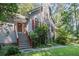 Home featuring a stone chimney, well-maintained lawn, and wooden steps at 1252 Grist Mill Dr, Acworth, GA 30101