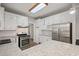 Modern kitchen with white cabinets, granite countertops, stainless steel appliances and recessed lighting at 1252 Grist Mill Dr, Acworth, GA 30101