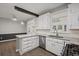 Well-lit kitchen with white cabinets, granite countertops, a stainless steel sink, and hardwood floors at 1252 Grist Mill Dr, Acworth, GA 30101