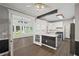 Open kitchen with granite countertops, stainless appliances, connecting to a bright sunroom with lots of light at 1252 Grist Mill Dr, Acworth, GA 30101