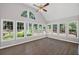 Bright sunroom with hardwood floors, vaulted ceiling, and large windows offering picturesque views of the outdoors at 1252 Grist Mill Dr, Acworth, GA 30101