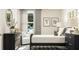 Bedroom featuring a black dresser with a round mirror, a comfortable white chair, and patterned wallpaper at 516 Almere Dr, Hampton, GA 30228