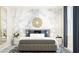 Elegant bedroom with a marble accent wall, unique lighting, and plush bedding for a cozy retreat at 516 Almere Dr, Hampton, GA 30228