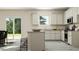 Bright, open kitchen featuring white cabinets, island seating, and a sliding glass door to the outside at 516 Almere Dr, Hampton, GA 30228