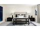 Serene main bedroom with upholstered bed, decorative wallpaper, and side tables at 516 Almere Dr, Hampton, GA 30228