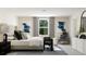 Bright main bedroom featuring a cozy bed, stylish decor, and a window view at 516 Almere Dr, Hampton, GA 30228