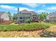 A spacious backyard featuring a patio area, lawn and mature landscaping at 6236 Millstone Trl, Douglasville, GA 30135