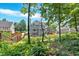 Landscaped backyard featuring a deck and mature trees at 6236 Millstone Trl, Douglasville, GA 30135