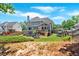 Spacious backyard with a deck, play area, and lush greenery, ideal for outdoor activities at 6236 Millstone Trl, Douglasville, GA 30135