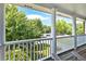View from the balcony featuring white pillars and lush greenery at 6236 Millstone Trl, Douglasville, GA 30135