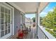 Relax on the balcony complete with rocking chairs and views of the neighborhood at 6236 Millstone Trl, Douglasville, GA 30135