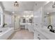 Elegant bathroom featuring double sinks, and large bathtub with glass shower at 6236 Millstone Trl, Douglasville, GA 30135