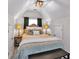 Bedroom with a bed, lamps, overhead lighting, and neutral-toned décor at 6236 Millstone Trl, Douglasville, GA 30135