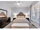 Cozy bedroom featuring a bed, dresser, nightstands, and a window with natural light at 6236 Millstone Trl, Douglasville, GA 30135