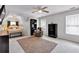 Bedroom with plush carpet, ceiling fan, dark furniture, and lots of natural light at 6236 Millstone Trl, Douglasville, GA 30135