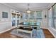 Comfortable dining area with large windows, a wooden table, chairs, and a stylish area rug at 6236 Millstone Trl, Douglasville, GA 30135