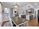 Bright dining area with hardwood floors, a large wooden table, and an open view of the kitchen at 6236 Millstone Trl, Douglasville, GA 30135