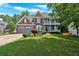 Charming two-story brick home with a well-manicured lawn, two-car garage, and balcony at 6236 Millstone Trl, Douglasville, GA 30135