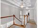 Hallway featuring hardwood stairs and decorative ceiling with an ornamental hanging light at 6236 Millstone Trl, Douglasville, GA 30135