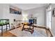 Well-lit home office with a work desk, shelving, and decorative art at 6236 Millstone Trl, Douglasville, GA 30135
