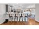 Stylish kitchen featuring a breakfast bar with seating for four, stainless appliances and hardwood floors at 6236 Millstone Trl, Douglasville, GA 30135