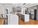 Modern kitchen with gray cabinetry, stainless steel appliances, and a center island with a white countertop at 6236 Millstone Trl, Douglasville, GA 30135