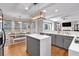 Open concept kitchen with island, stainless appliances, and connection to a breakfast nook with backyard views at 6236 Millstone Trl, Douglasville, GA 30135