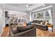 Bright living room with large windows offering a view to the outside and open access to the kitchen at 6236 Millstone Trl, Douglasville, GA 30135