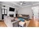 Inviting living room with a fireplace, a ceiling fan, and comfortable sofas with a view of the entry hall at 6236 Millstone Trl, Douglasville, GA 30135