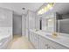 Well-lit bathroom with double vanity, granite countertops, and elegant gold fixtures at 1030 Carriage Trace Cir, Stone Mountain, GA 30087