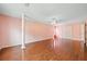 Spacious bedroom featuring hardwood floors, ceiling fan, and pink walls at 1030 Carriage Trace Cir, Stone Mountain, GA 30087