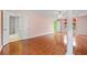 Bright bedroom with hardwood floors, pink walls, ceiling fan and attached bathroom at 1030 Carriage Trace Cir, Stone Mountain, GA 30087