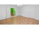 Bright bedroom with hardwood flooring and access to a hallway with stairs at 1030 Carriage Trace Cir, Stone Mountain, GA 30087