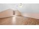 Angled ceiling bedroom with fan, hardwood floors, and window at 1030 Carriage Trace Cir, Stone Mountain, GA 30087