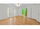Well-lit bedroom showcasing hardwood floors and view into a hallway at 1030 Carriage Trace Cir, Stone Mountain, GA 30087