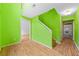 Bright foyer features a wood floor, a staircase, and lime green walls at 1030 Carriage Trace Cir, Stone Mountain, GA 30087
