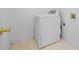 Functional laundry room with modern appliance and tiled flooring at 1030 Carriage Trace Cir, Stone Mountain, GA 30087