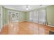 Inviting living room with tile flooring, large windows, and a view into the kitchen area at 1030 Carriage Trace Cir, Stone Mountain, GA 30087