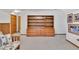 Basement featuring neutral carpet and a large wooden shelving unit with built-in drawers and cabinets at 2071 Habersham Cir, Covington, GA 30014