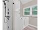 Contemporary bathroom features a glass shower and walk-in tub surrounded by large windows at 2071 Habersham Cir, Covington, GA 30014