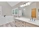 Bathroom featuring double sinks, white cabinets, and a walk-in tub at 2071 Habersham Cir, Covington, GA 30014