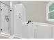 Modern bathroom with a glass-enclosed shower and walk-in tub at 2071 Habersham Cir, Covington, GA 30014