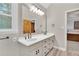 Bright bathroom featuring double sinks, large vanity and natural light from a large window at 2071 Habersham Cir, Covington, GA 30014