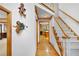 Grand foyer featuring a staircase, hardwood floors, and views into the kitchen and dining areas at 2071 Habersham Cir, Covington, GA 30014