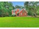 Beautiful red brick two-story home with an expansive green lawn at 2071 Habersham Cir, Covington, GA 30014