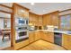 Bright kitchen featuring wooden cabinets, stainless steel appliances, and a gas cooktop at 2071 Habersham Cir, Covington, GA 30014