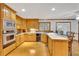 A spacious kitchen with wood cabinets and countertops, stainless appliances and hardwood floors at 2071 Habersham Cir, Covington, GA 30014