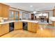 Open kitchen with wooden cabinetry, stainless appliances, an island, and hardwood flooring at 2071 Habersham Cir, Covington, GA 30014