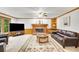Traditional living room with fireplace, leather furniture, carpet, and built-in shelves at 2071 Habersham Cir, Covington, GA 30014