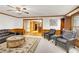 Living room with hardwood floors and leather furniture leading into a kitchen at 2071 Habersham Cir, Covington, GA 30014